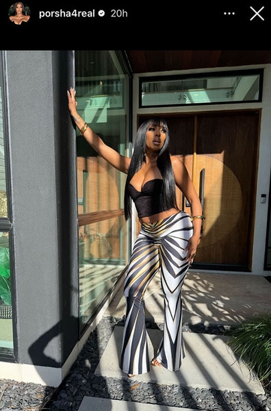 Porsha Williams posing outdoors with bangs and long hair.