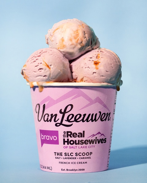 A pint of Van Leeuven ice cream with three scoops popping out on a blue background.