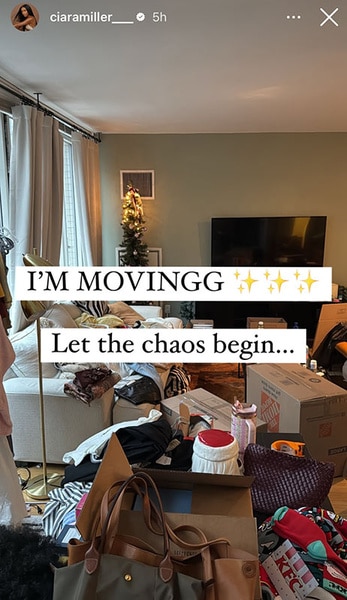 Moving boxes and personal items in Ciara Miller's living room.