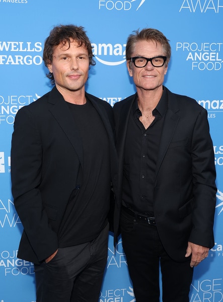 Harry Hamlin and Dimitri Hamlin smiling in front of a step and repeat.