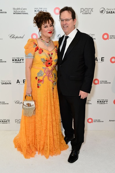 Jennifer Tilly and Phil Laak posing in front of a step and repeat.