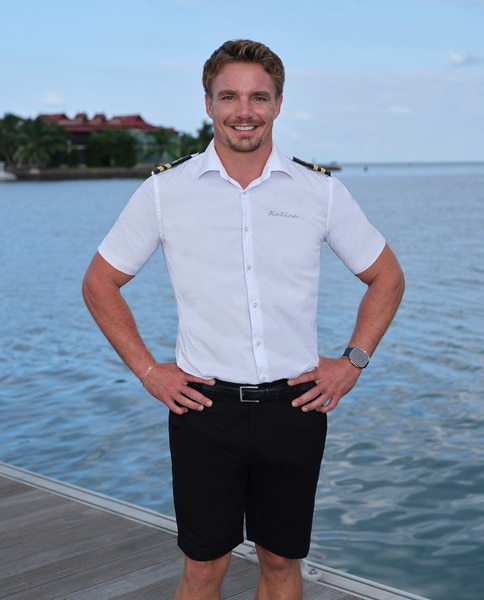 Wihan Du Toit wearing his yaching uniform in front of water