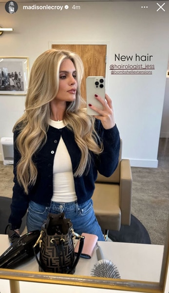 Madison Lecroy takes a selfie of herself looking into a mirror at a salon