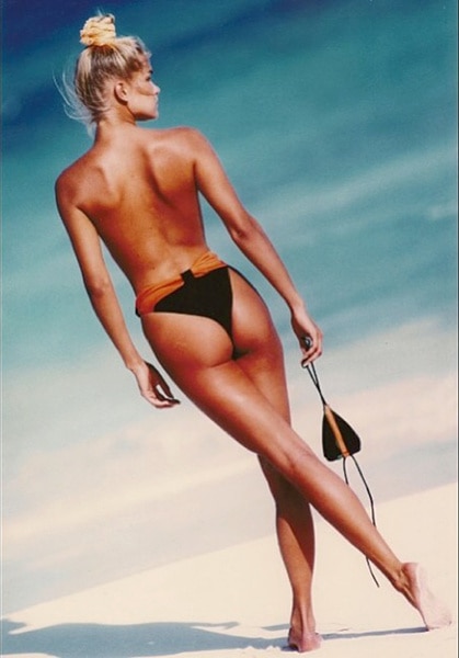 Yolanda Hadid on the beach topless wearing black bikini bottoms