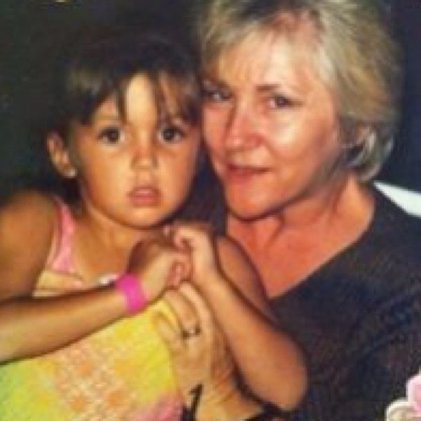A young Ashlee Holmes from the Real Housewives of New Jersey sitting with her grandmother