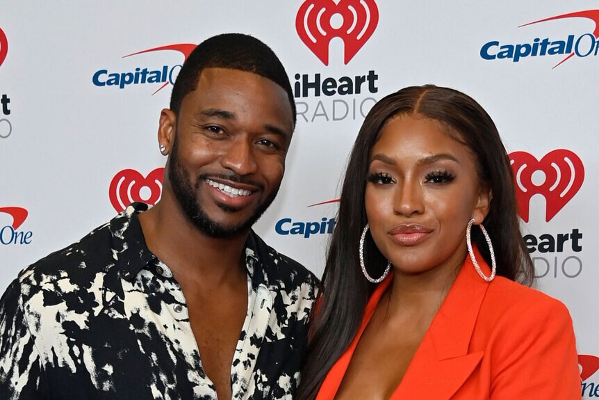 Drew Sidora and Ralph Pittman pose together on a step and repeat.