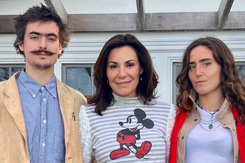 Luann, Victoria, and Noah pose for a photo together outdoors.