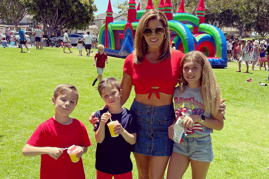 Emily Simpson and her children pose for a photo together.