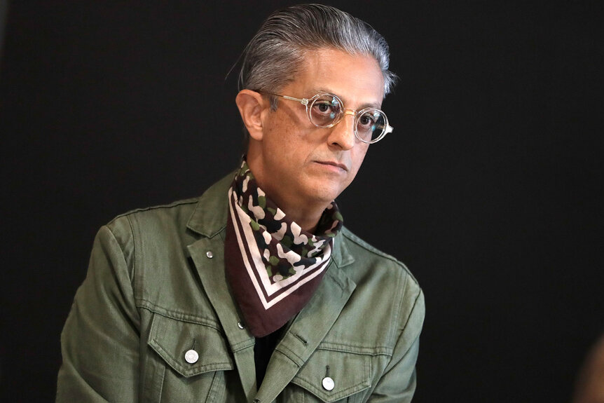 Max Vadukul wearing a scarf and a military jacket at a Photo Walks event at a Brooklyn, NY apple store.