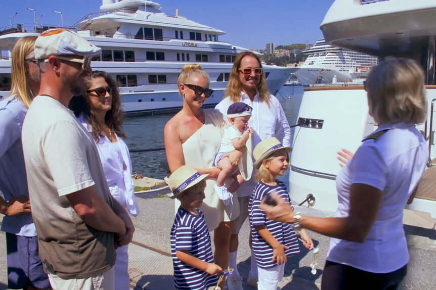 Roy Orbinson Jr. and his family talking to Captain Sandy before they go on their yacht charter.