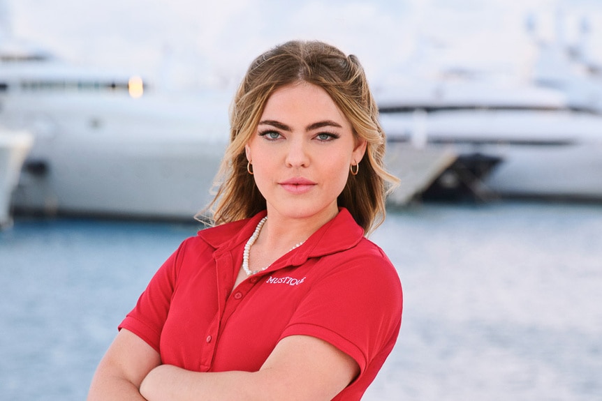 Sabrina Muller wearing a red polo on a boat marina
