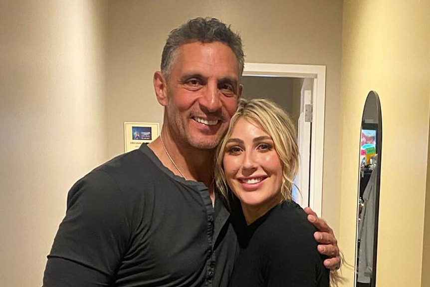 Mauricio Umansky and Emma Slater posing together.