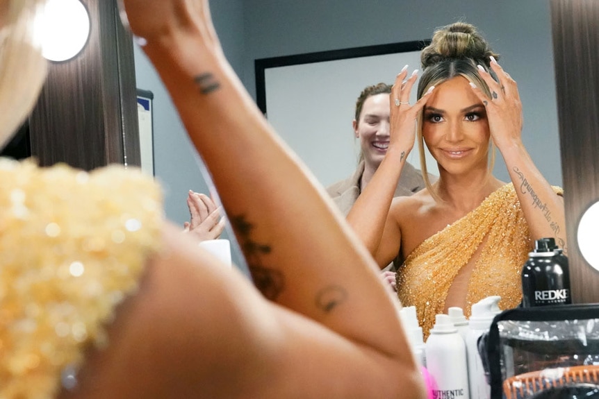 Scheana Shay fixing her hair in a mirror at the Vanderpump Rules reunion