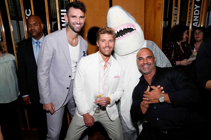 Carl Radke, Kyle Cooke and Joe Gorga with a person in a shark costume at WWHL