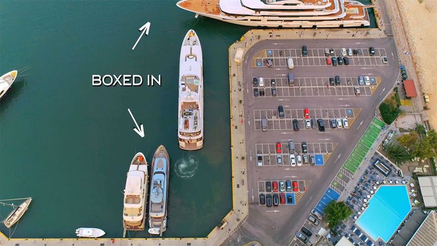An aerial view of the Mustique yacht boxed in by two other yachts.