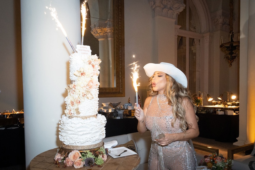 Larsa Pippen blowing out candles on her birthday cake.