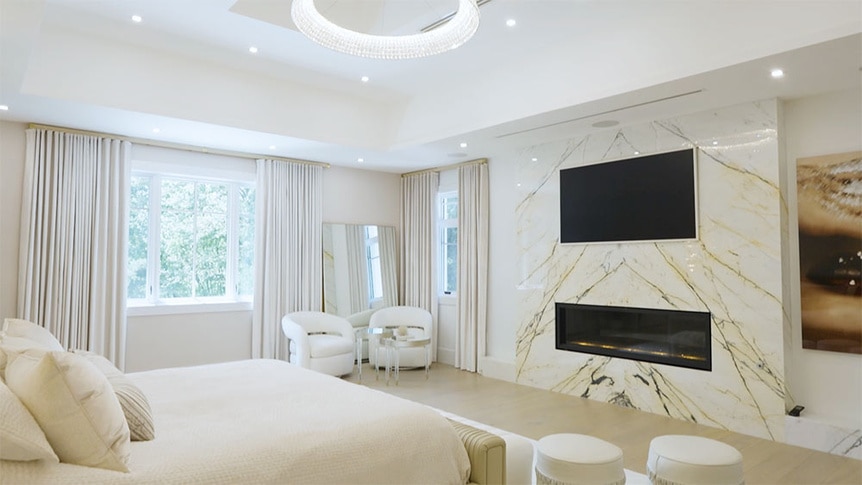 Melissa Gorga's bedroom with seating, lighting, and a fireplace.