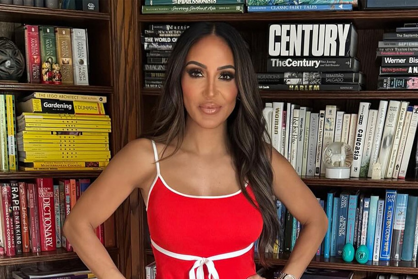 Melissa Gorga posing in front of a bookshelf.