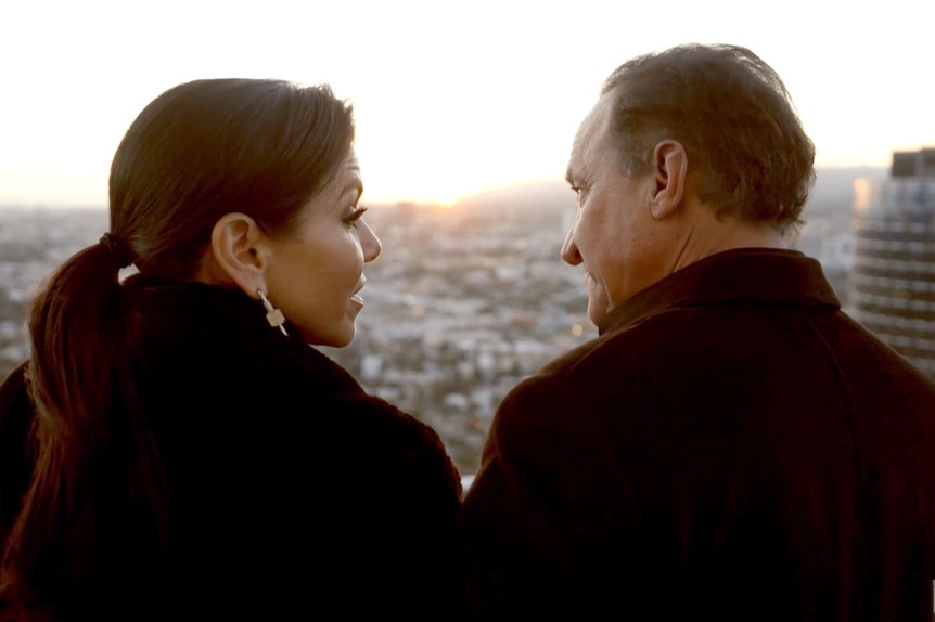 Heather Dubrow with her husband Terry Dubrow sharing a romantic moment on their patio