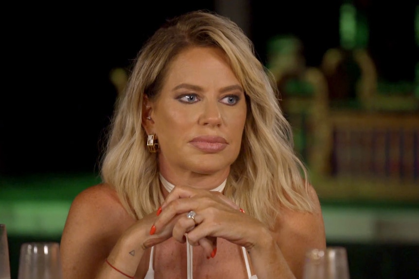 Caroline Stanbury at a dinner table.