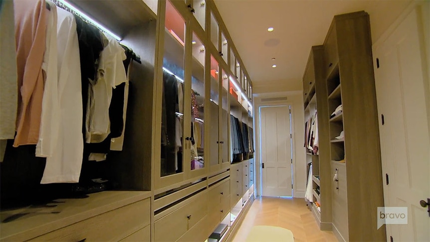 Ryan Serhant's closet with his suits and shirts.