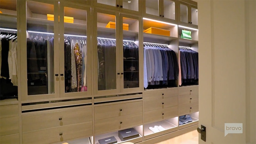 Ryan Serhant's closet with his suits and shirts.