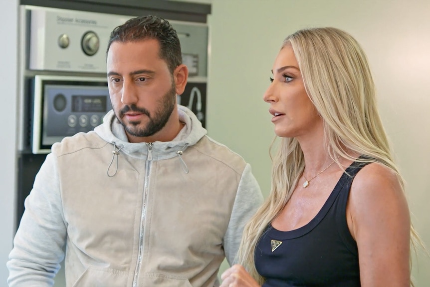 Josh Altman and Heather Altman talking and standing next to each other.