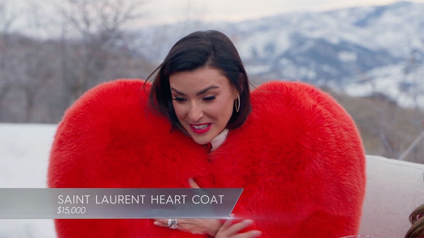 Bronwyn Newport talking while in a heart shaped coat.