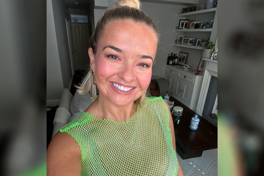 Daisy Kelliher wearing a green mesh top in a living room