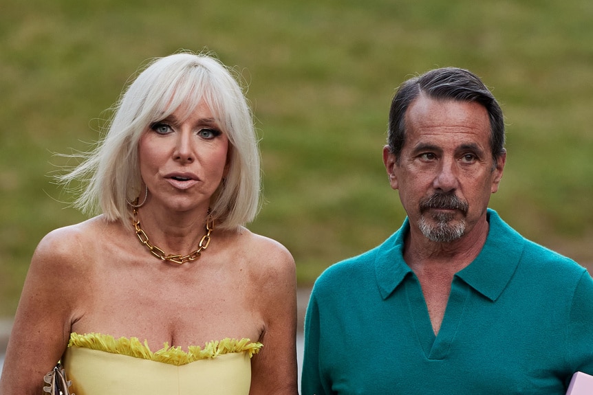 Margaret Josephs and Joe Benigno walking together outdoors.