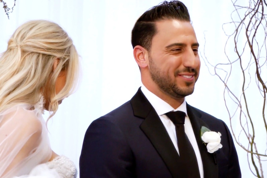 Heather Altman walks around Josh Altman on their wedding day.