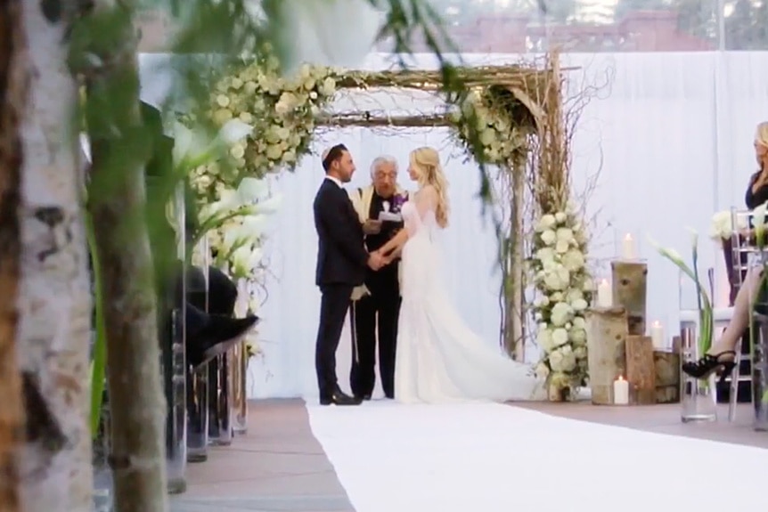 Josh Altman and Heather Altman under the chuppah on their wedding day.