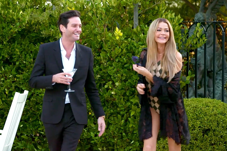 Josh Flagg and Denise Richards outside laughing together