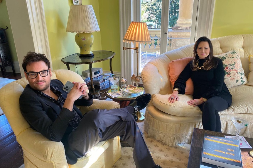 Patricia Altschul and Whitney Sudler-Smith sitting inside their home on sofas.