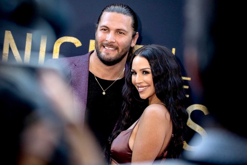 Brock Davies and Scheana Marie on the red carpet with some blur in the foreground