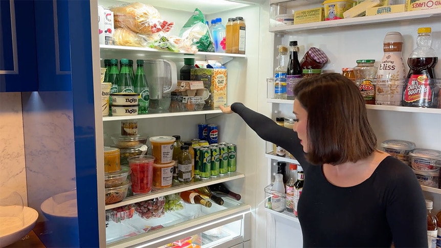 Bronwyn Newport standing and talking in front of her fridge.