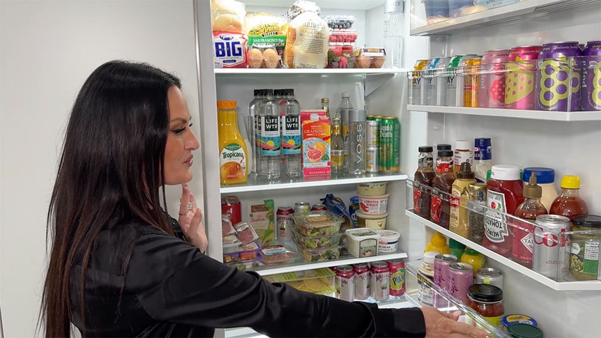 Lisa Barlow standing and talking in front of her fridge.