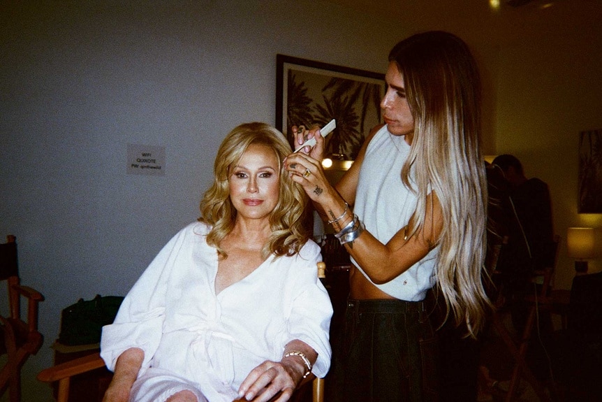 A stylist works on Kathy Hilton's hair backstage at the RHOBH Season 14 press shoot