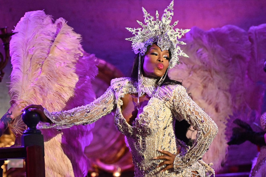 Quad Webb in a jeweled outfit and a crown during a performance