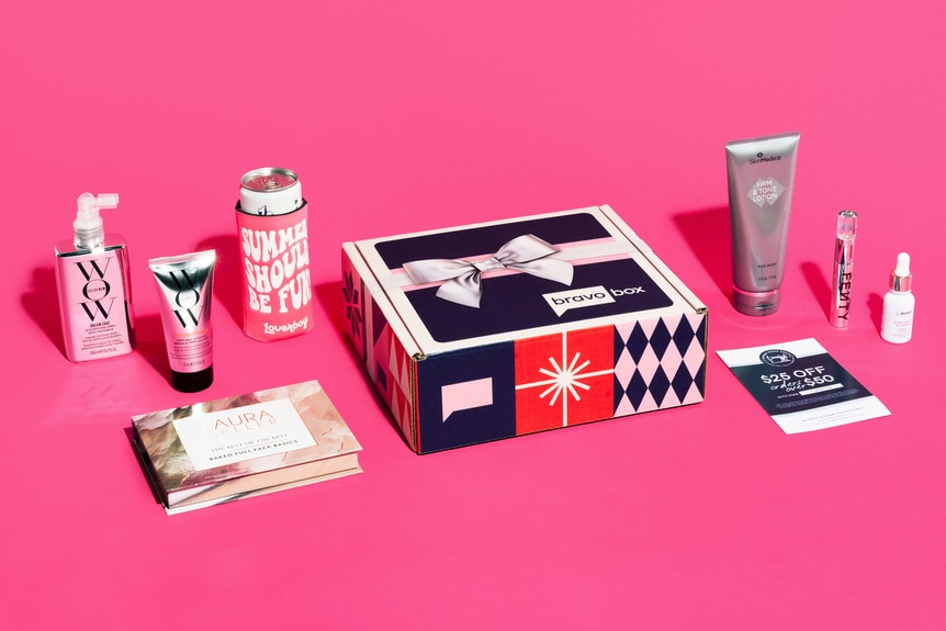 A box with beauty products on a pink background