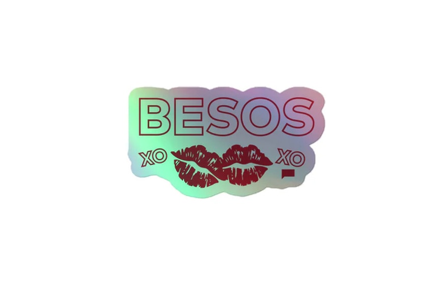 A iridescent sticker with Besos written on it and two lip graphics