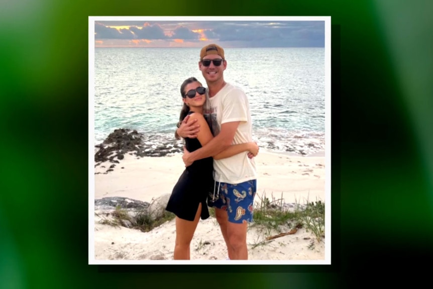 Austen Kroll and his girlfriend, Audrey, hugging each other on the beach