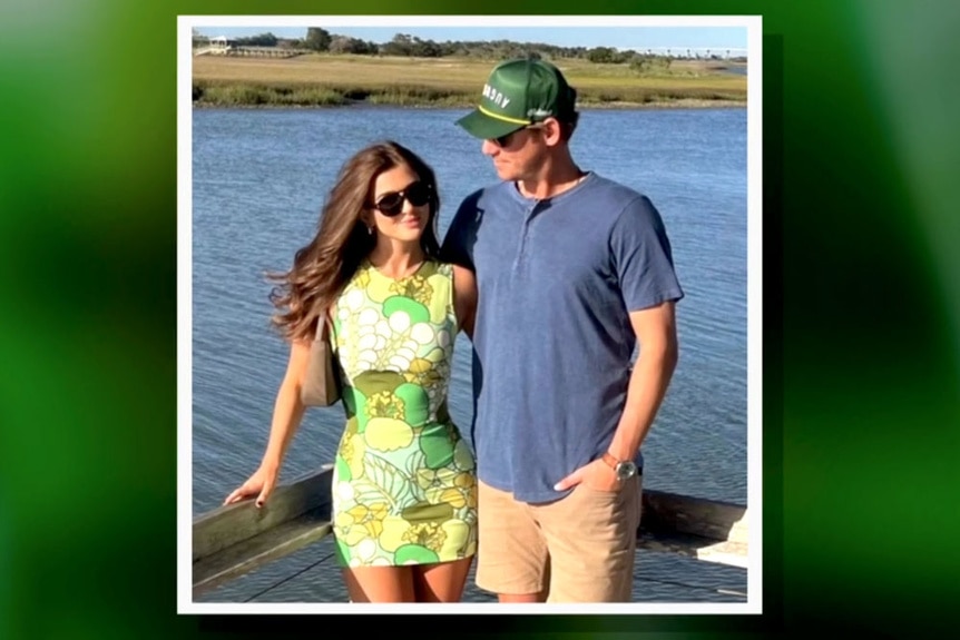 Austen Kroll and his girlfriend Audrey seen on a deck overlooking a body of water together.