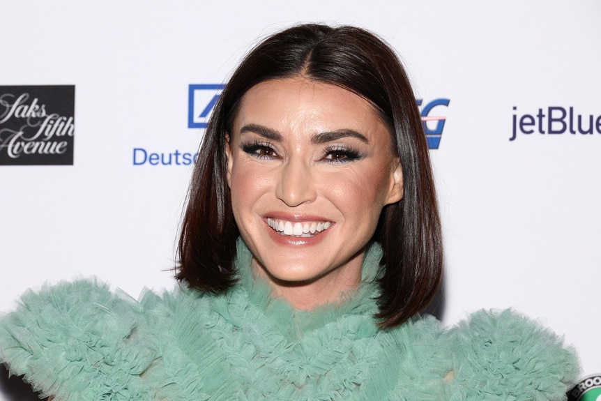 Bronwyn Newport wearing a green dress on a step and repeat