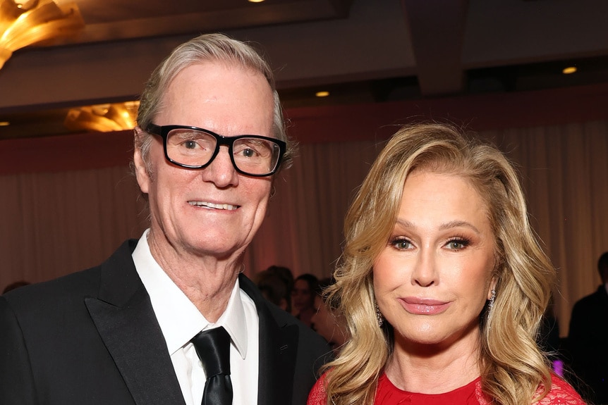 Kathy Hilton and Rick Hilton posing together at an event.