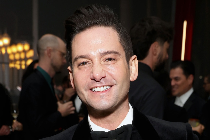 Josh Flagg smiling at an event.