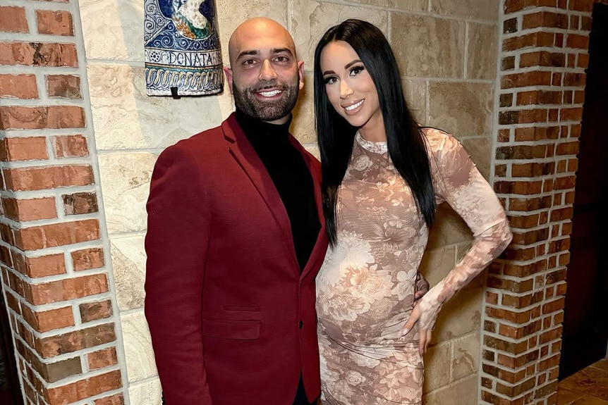 Rachel Fuda with her husband John Fuda standing next to each other at a party